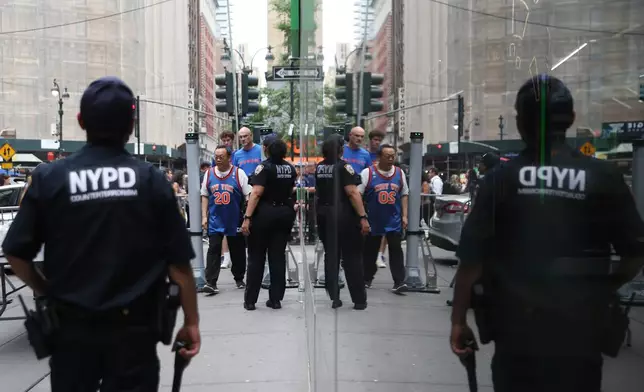 Fans pass a security checkpoint on Sixth Avenue outside of Madison Square Garden ahead of Game 4 of the NBA Finals between the New York Knicks and San Antonio Spurs, Wednesday, June 10, 2026, in New York. (AP Photo/Heather Khalifa)