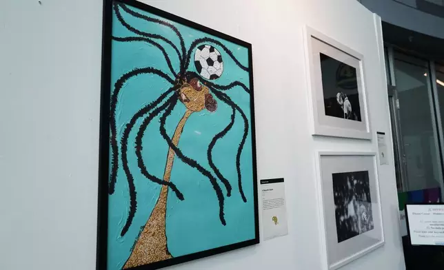 A painting of a woman heading a soccer ball titled, "A Beautiful Game," by artist Tasanee Durrett is displayed at an exhibition, "Art and the Beautiful Game: Africa on the World Stage," on June 1, 2026, in North Miami, Fla. (AP Photo/Lynne Sladky)