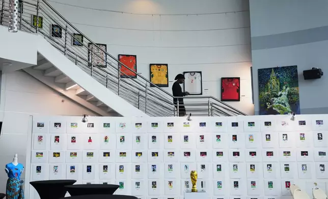 A person walks among artwork displayed at an exhibition, "Art and the Beautiful Game: Africa on the World Stage," on June 1, 2026, in North Miami, Fla. (AP Photo/Lynne Sladky)