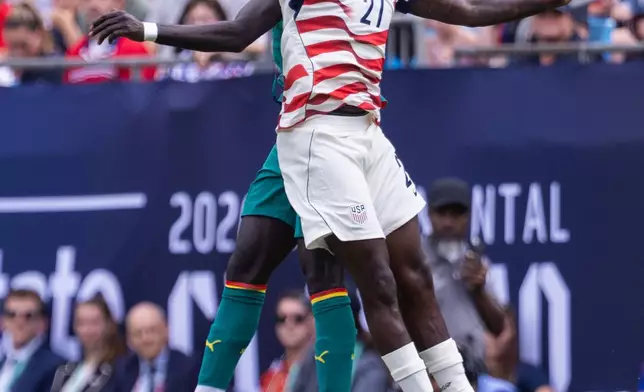 Senegal defender Malick Diouf, left, and United States forward Tim Weah (21) vie for a header during the second half of an international friendly soccer match Sunday, May 31, 2026, in Charlotte, N.C. (AP Photo/Scott Kinser)