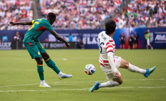 Senegal defender Malick Diouf (25) shoots against United States during the second half of an international friendly soccer match Sunday, May 31, 2026, in Charlotte, N.C. (AP Photo/Scott Kinser)