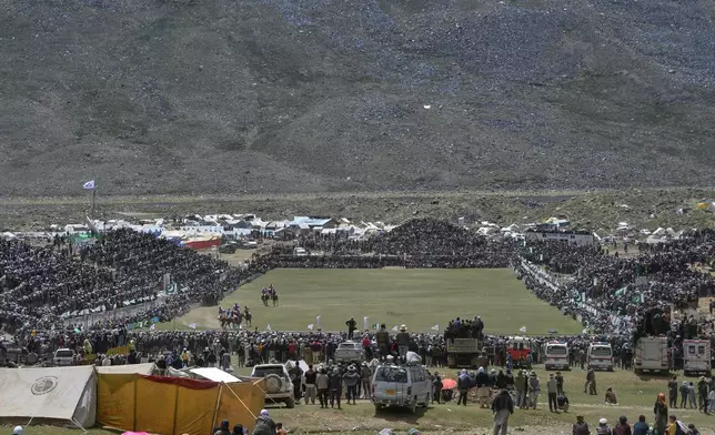 Spectators watch the final polo match between Chitral region team and Gilgit-Baltistan region team during the three-day annual Shandur Polo Festival in Shandur Pass, in the Ghizer district of Gilgit-Baltistan, northern Pakistan, Saturday, June 13, 2026. (AP Photo/Zubair Abbasi)