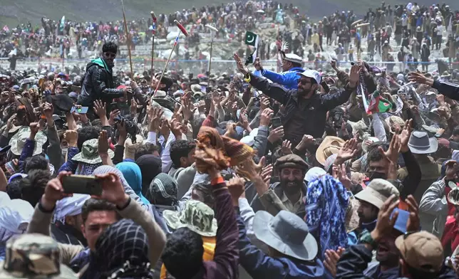 Players of Gilgit-Baltistan region team and their supporters celebrate after their team won the final polo match against Chitral region team during the three-day annual Shandur Polo Festival in Shandur Pass, in the Ghizer district of Gilgit-Baltistan, northern Pakistan, Saturday, June 13, 2026. (AP Photo/Zubair Abbasi)