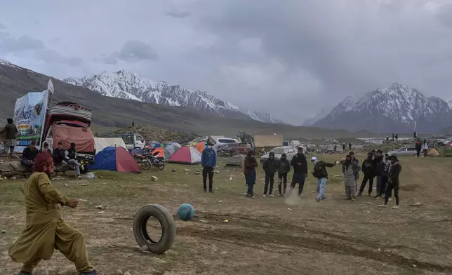 Spectators play a game at a temporary tent settlement during the three-day annual Shandur Polo Festival in Shandur Pass in the Ghizer district of Gilgit-Baltistan, northern Pakistan, Friday, June 12, 2026. (AP Photo/Zubair Abbasi)