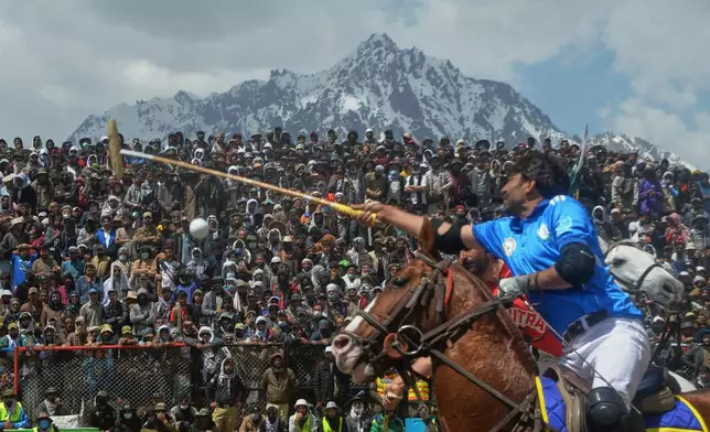 A player reaches for the ball during the final polo match in the three-day annual Shandur Polo Festival in Shandur Pass, in the Ghizer district of Gilgit-Baltistan, northern Pakistan, Saturday, June 13, 2026. (AP Photo/Zubair Abbasi)