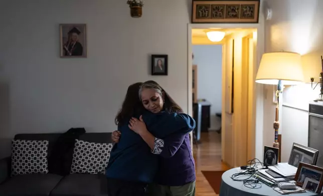 Masuma Khan, right, an immigrant from Bangladesh who was held at an immigration detention facility in California City the previous year, hugs her daughter, Riya, after an interview with a news outlet in Altadena, Calif., April 21, 2026. (AP Photo/Jae C. Hong)
