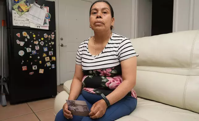 Maria Jose Gonzalez holds a photo of her husband, Jose-Antonio Segismundo, who was detained for six months at "Alligator Alcatraz," April 16, 2026, in Wimauma, Fla. (AP Photo/Chris O'Meara)