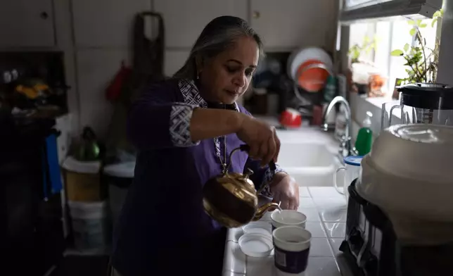 Masuma Khan, an immigrant from Bangladesh who was held at an immigration detention facility in California City the previous year, makes tea in her home in Altadena, Calif., April 21, 2026. (AP Photo/Jae C. Hong)