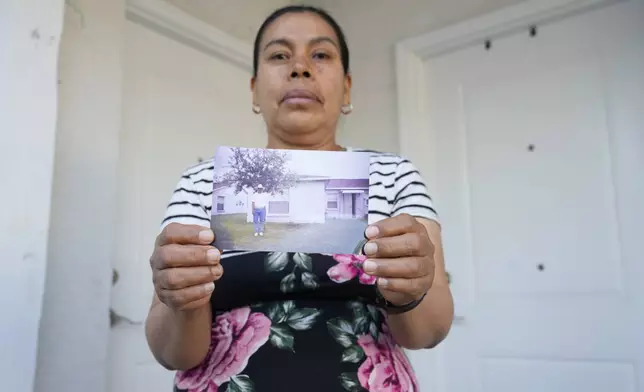 Maria Jose Gonzalez holds a photo of her husband, Jose-Antonio Segismundo, who was detained for six months at "Alligator Alcatraz," April 16, 2026, in Wimauma, Fla. (AP Photo/Chris O'Meara)