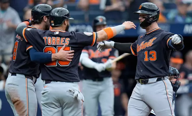 Detroit Tigers' Dillon Dingler (13) celebrates his three-run home run off Tampa Bay Rays pitcher Nick Martinez with Matt Vierling (8) and Gleyber Torres (25) during the fourth inning of a baseball game Wednesday, June 3, 2026, in St. Petersburg, Fla. (AP Photo/Chris O'Meara)