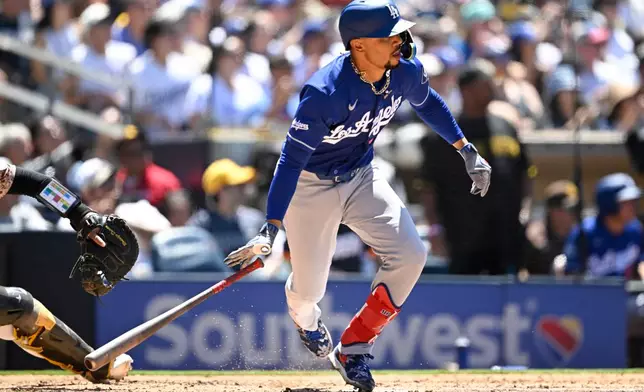 Los Angeles Dodgers' Mookie Betts watches his RBI single during the fifth inning of a baseball game against the San Diego Padres, Sunday, June 28, 2026, in San Diego. (AP Photo/Denis Poroy)