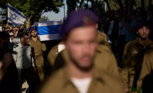 Israeli soldiers carry the coffin of Staff-Sergeant Michael Tyukin, who was killed in a drone attack in southern Lebanon, during his funeral in Ashkelon, Israel, Monday, June 1, 2026. (AP Photo/Leo Correa)