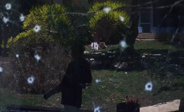 A person walks past the site struck by a rocket fired from Lebanon on Saturday in Kiryat Shmona, northern Israel, Sunday, May 31, 2026. (AP Photo/Ariel Schalit)