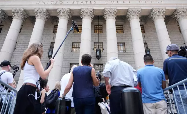 Reporters and others wait outside of a federal courthouse during a hearing for Luigi Mangione in New York, Monday, June 29, 2026. (AP Photo/Seth Wenig)