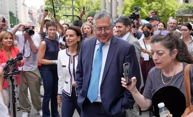 Marc Agnifilo, center right, and Karen Friedman Agnifilo, center left, lawyers for Luigi Mangione, are surrounded by media as they leave a federal courthouse in New York, Monday, June 29, 2026. (AP Photo/Seth Wenig)