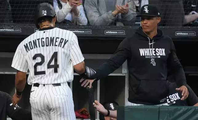 Chicago White Sox's Braden Montgomery is greeted by manager Will Venable, right, after scoring against the Atlanta Braves during the fourth inning in a baseball game, Wednesday, June 10, 2026, in Chicago. (AP Photo/David Banks)