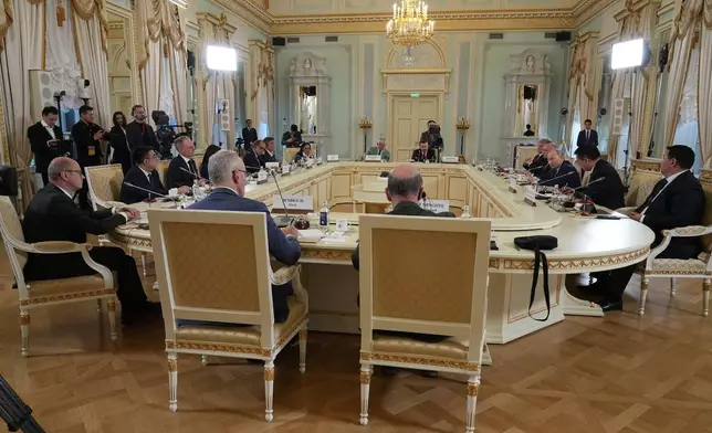 Russian President Vladimir Putin, background third right, meets with representatives of international news agencies on the sidelines of the St. Petersburg International Economic Forum at the Constantine Palace in St. Petersburg, Russia, on Thursday, June 4, 2026. (AP Photo/Dmitri Lovetsky, Pool)