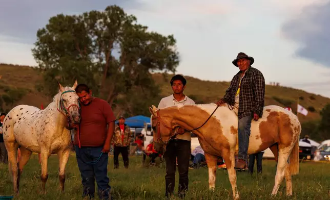 Riders wait for the horse ceremony to begin during festivities commemorating the 150th anniversary of the Battle of the Little Bighorn, Wednesday, June 24, 2026, in Crow Agency, Mont. (AP Photo/Tailyr Irvine)