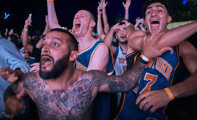 New York Knicks fans celebrate their victory after a watch party for Game 5 of the NBA Finals basketball series against the San Antonio Spurs, Saturday, June 13, 2026, in New York. (AP Photo/Andres Kudacki)