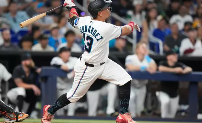 Miami Marlins' Heriberto Hernandez (13) watches after hitting a two run home run during the fourth inning of a baseball game against the San Francisco Giants, Saturday, June 20, 2026, in Miami. (AP Photo/Lynne Sladky)