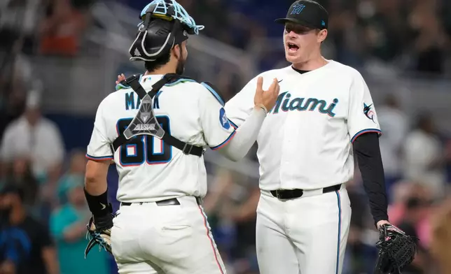 Miami Marlins relief pitcher Pete Fairbanks, right, reacts with starting pitcher Joe Mack (80) after the Marlins defeated the San Francisco Giants in a baseball game, June 20, 2026, in Miami. (AP Photo/Lynne Sladky)