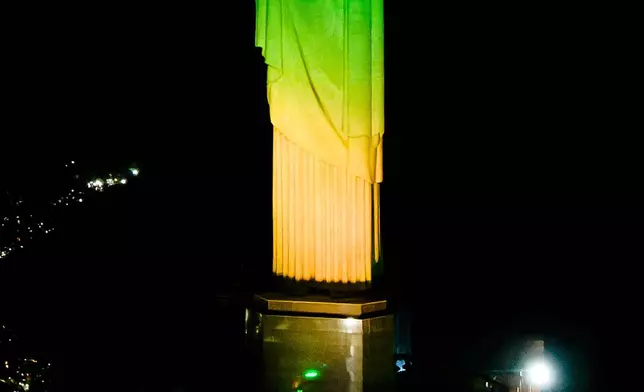Christ the Redeemer monument is illuminated in Brazil's national colors as part of the countdown to the 2027 FIFA Women's World Cup, in Rio de Janeiro, Brazil, Tuesday, June 23, 2026. (AP Photo/Dhavid Normando)