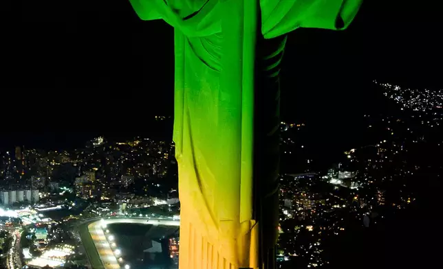 Christ the Redeemer monument is illuminated in Brazil's national colors as part of the countdown to the 2027 FIFA Women's World Cup, in Rio de Janeiro, Brazil, Tuesday, June 23, 2026. (AP Photo/Dhavid Normando)
