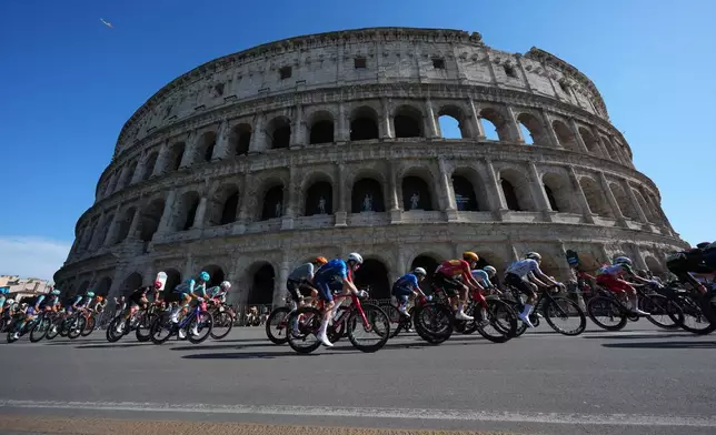 The pack rides past the ancient Colosseum during the 21th and last stage of the Giro d'Italia cycling race in Rome, Sunday May 31, 2026. (AP Photo/Andrew Medichini)