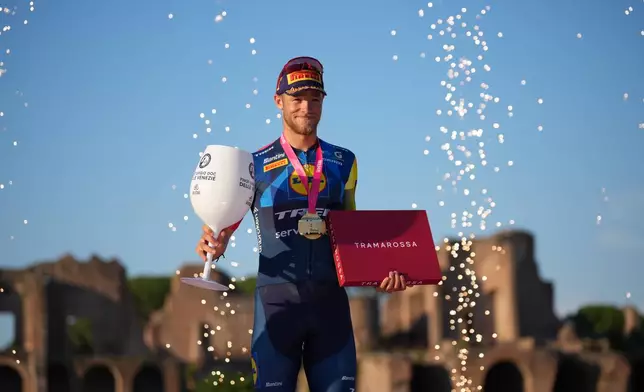 Italy's Jonathan Milan celebrates on the podium after winning the last stage of the Giro d'Italia in Rome Sunday May 31, 2026. (AP Photo/Andrew Medichini)