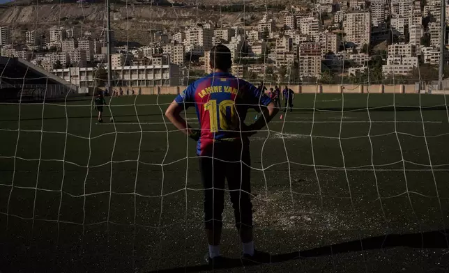 Wearing a Barcelona jersey bearing the name of Spanish soccer player Lamine Yamal, a Palestinian youth from a local soccer academy takes part in a training session at the municipal stadium in the West Bank city of Nablus, Thursday, May 7, 2026. (AP Photo/Leo Correa)