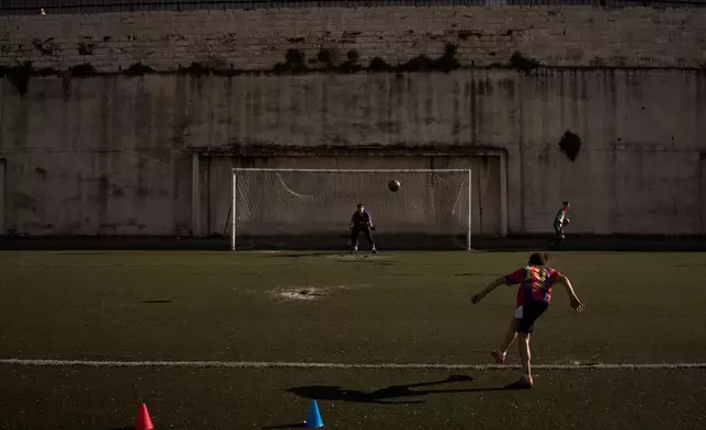 A Palestinian boy from a local soccer academy wearing a Barcelona jersey kicks a ball during a practice session at the municipal stadium in the West Bank city of Nablus, Thursday, May 7, 2026. (AP Photo/Leo Correa)