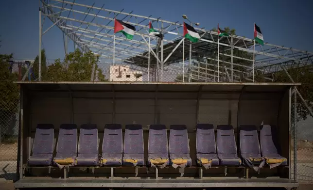 A referees' bench with torn seats is seen next to the field at Dura International Stadium in the West Bank town of Dura, near Hebron, Monday, May 25, 2026. (AP Photo/Leo Correa)