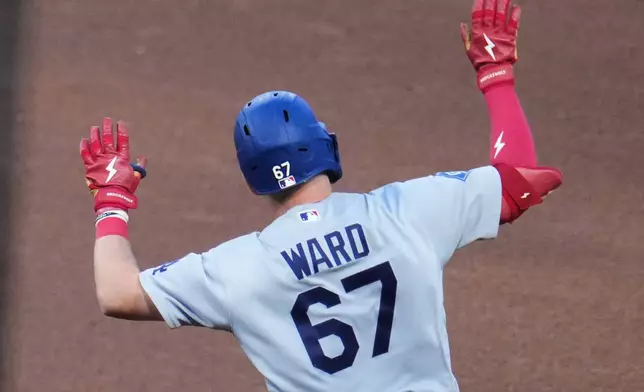 Los Angeles Dodgers' Ryan Ward celebrates as he rounds the bases after hitting a grand slam home run off Pittsburgh Pirates pitcher Carmen Mlodzinski during the sixth inning of a baseball game in Pittsburgh, Wednesday, June 10, 2026. (AP Photo/Gene J. Puskar)