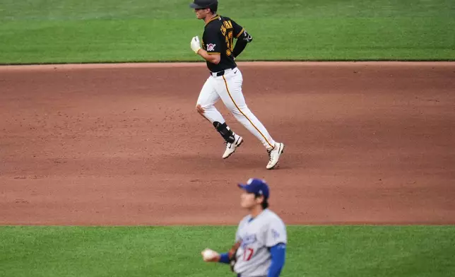 Pittsburgh Pirates' Tyler Callihan, top, rounds the bases after hitting a solo home run off Los Angeles Dodgers two-way player Shohei Ohtani (17) during the fourth inning of a baseball game in Pittsburgh, Wednesday, June 10, 2026. (AP Photo/Gene J. Puskar)