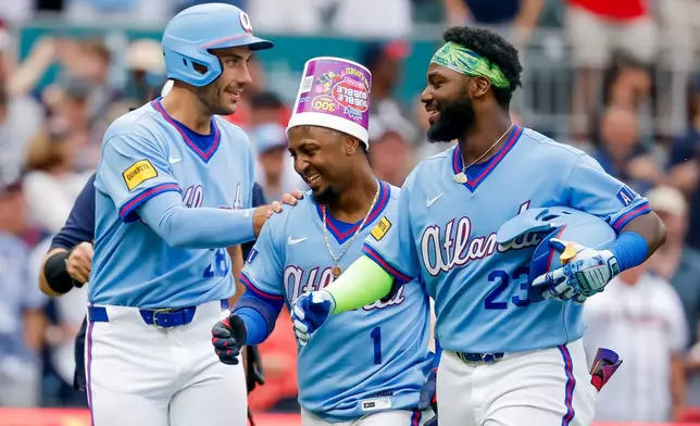 Atlanta Braves' Ozzie Albies, center, celebrates with celebrates with teammates Matt Olson, left, and Michael Harris II, after hitting a game-winning two-run home run against the Milwaukee Brewers during the ninth inning of a baseball game, Saturday, June 20, 2026, in Atlanta. (AP Photo/Erik S. Lesser)