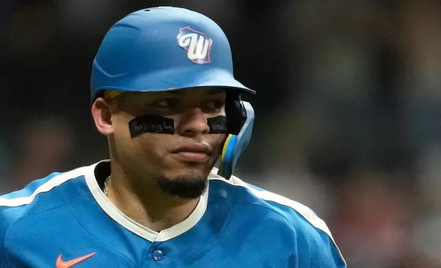 Milwaukee Brewers' William Contreras wears eye black that reads "Praying for Venezuela" as he rounds the bases after hitting a two-run home run during the seventh inning of a baseball game against the Chicago Cubs, Friday, June 26, 2026, in Milwaukee. (AP Photo/Aaron Gash)
