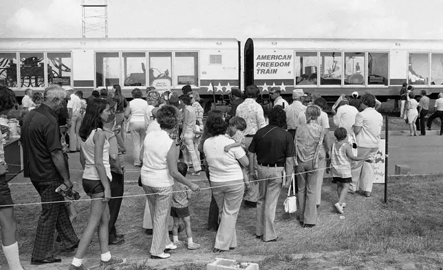 FILE - People wait in line to see the American Freedom Train in Archbold, Ohio, June 20, 1975. (AP Photo/File)