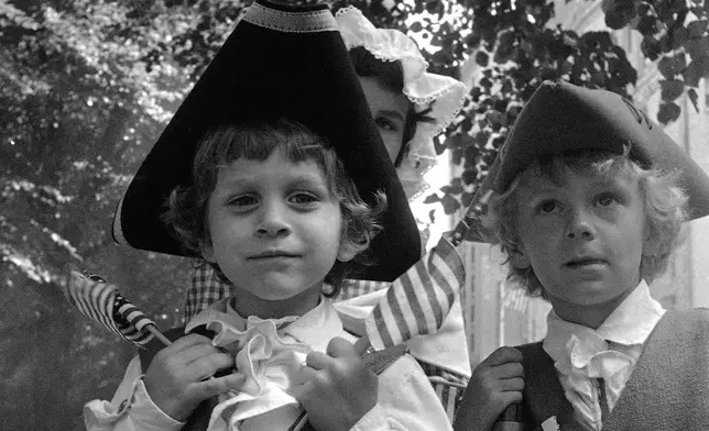 FILE - Five-year-old Thomas Scott of Bridgewater, Mass., celebrates the U.S. bicentennial in Boston's Fourth of July parade, Sunday, July 4, 1976. (AP Photo/File)