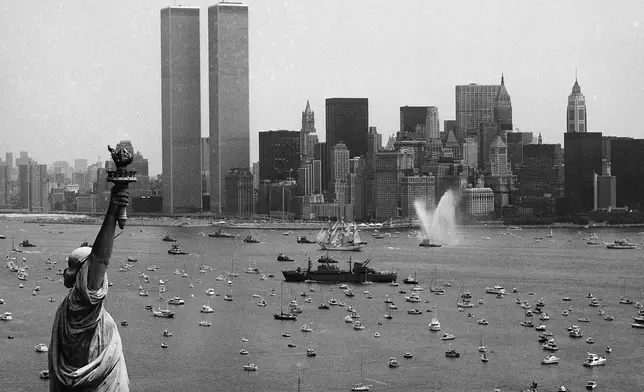 FILE - Ships participate in Operation Sail between the Statue of Liberty and the World Trade Center to celebrate the U.S. bicentennial in New York on July 4, 1976. (AP Photo/Eddie Adams, File)