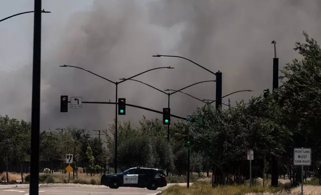 Smoke is seen from the massive fire at the Medline medical supply warehouse a million-foot facility, in Tracy, Calif., Friday, June 12, 2026. (Stephen Lam/San Francisco Chronicle via AP)