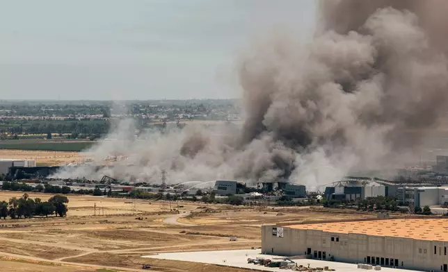 Smoke is seen from the massive fire at the Medline medical supply warehouse in Tracy, Calif., Friday, June 12, 2026. (Stephen Lam/San Francisco Chronicle via AP)