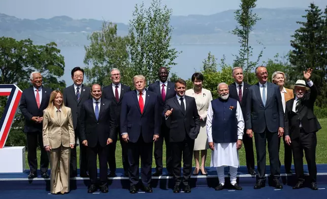 From left, European Council President Antonio Costa, Italian Prime Minister Giorgia Meloni, South Korea's President Lee Jae Myung, Egyptian President Abdel Fattah al-Sisi, British Prime Minister Keir Starmer, U.S. President Donald Trump, Kenya's President William Ruto, French President Emmanuel Macron, Japanese Prime Minister Sanae Takaichi, India's Prime Minister Narendra Modi, Canadian Prime Minister Mark Carney, German Chancellor Friedrich Merz, European Commission President Ursula von der Leyen, Brazilian President Luiz Inacio Lula da Silva gather for a group photo at the G7 summit in Evian-les-Bains, France, Tuesday June 16, 2026. (Isabel Infantes/Pool Photo via AP)
