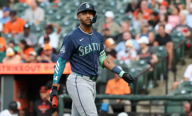 Seattle Mariners' Julio Rodríguez walks off the field after striking out against Baltimore Orioles pitcher Brandon Young during the third inning of a baseball game, Wednesday, June 10, 2026, in Baltimore. (AP Photo/Terrance Williams)
