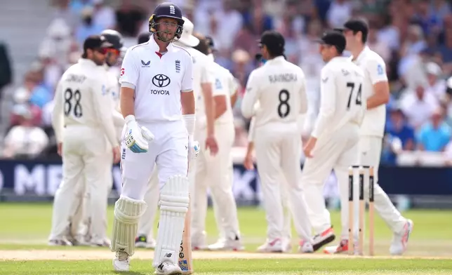 England's Joe Root, foreground, reacts after being bowled out by New Zealand's Nathan Smith via lbw during day three of the Third Test cricket match between England and New Zealand, in Nottingham, England, Saturday June 27, 2026. (Mike Egerton/PA via AP)