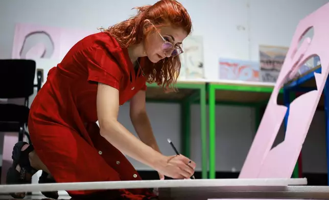 Designer Fatma Paja handcrafts foam flamingos in order to be used at protests against a coastal development project in western Albania linked to Jared Kushner, son-in-law of President Donald Trump, in Tirana, Albania, Friday, June 26, 2026. (AP Photo/Hameraldi Agolli)