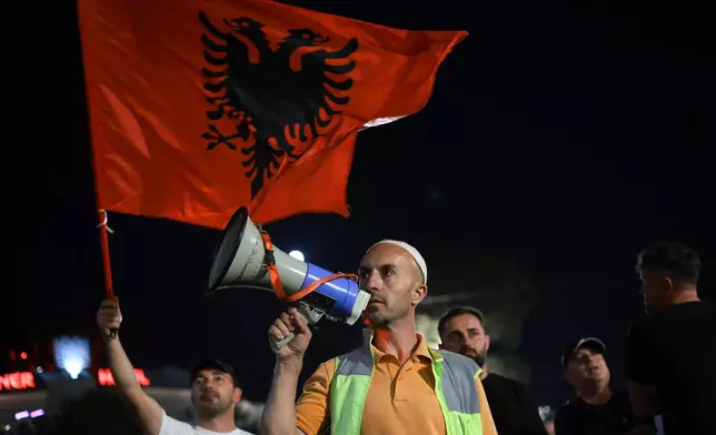 Arben Kola, a tour guide and one of the protesters against a coastal development project in western Albania linked to Donald Trump's son-in-law Jared Kushner, is photographed during a rally in Tirana, Albania, Saturday, June 27, 2026. (AP Photo/Hameraldi Agolli)