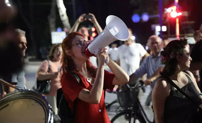 Designer Fatma Paja, center takes part in a protest against a coastal development project in western Albania linked to Jared Kushner, son-in-law of President Donald Trump, in Tirana, Albania, Friday, June 26, 2026. (AP Photo/Hameraldi Agolli)
