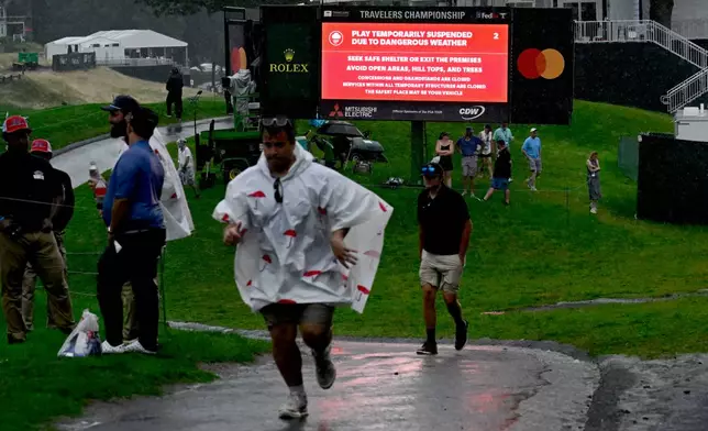 A sign announces that play is temporarily suspended due to dangerous weather during the final round of the Travelers Championship golf tournament at TPC River Highlands, Sunday, June 28, 2026, in Cromwell, Conn. (AP Photo/Jessica Hill)