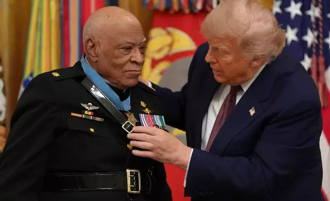 President Donald Trump, right, awards retired Marine Maj. James Capers the Medal of Honor in the East Room of the White House, Thursday, June 18, 2026, in Washington. (AP Photo/Jacquelyn Martin)