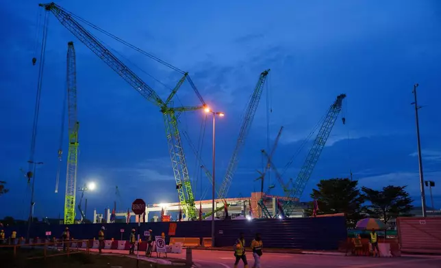 FILE - Workers walk outside a data center building under construction in Johor Bahru town at Johor state, Sept. 28, 2024. (AP Photo/Vincent Thian, File)